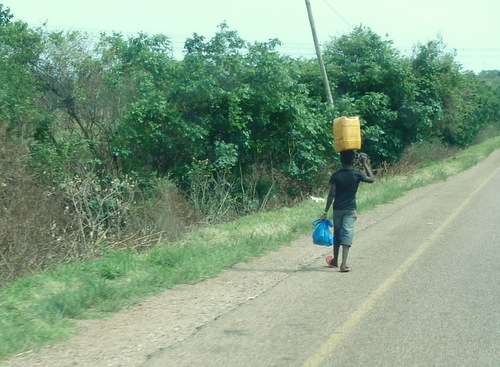 Boy carrying Water or Fuel.